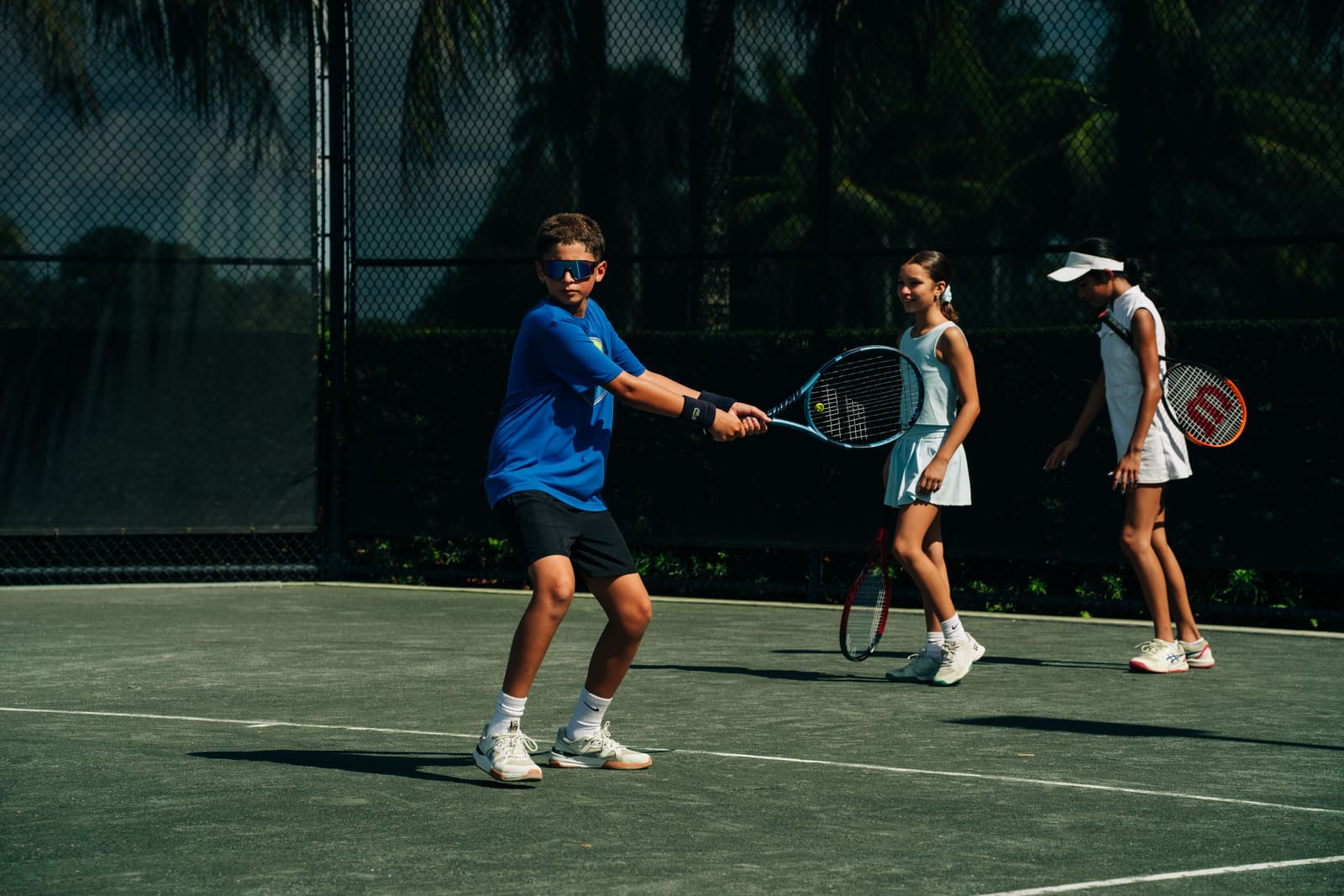 Juniors on court during a group class